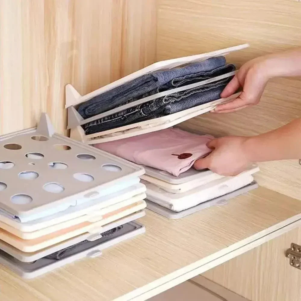 Foldable clothing organizer being used to sort folded clothes on a wooden surface grandline retail